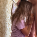 woman in pink on her knees sucking dick