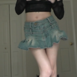 goth girl dancing for the camera while stripping